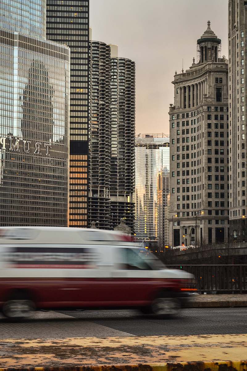 building A blurry car on a bridge in a city with skyscrapers at the back downtown