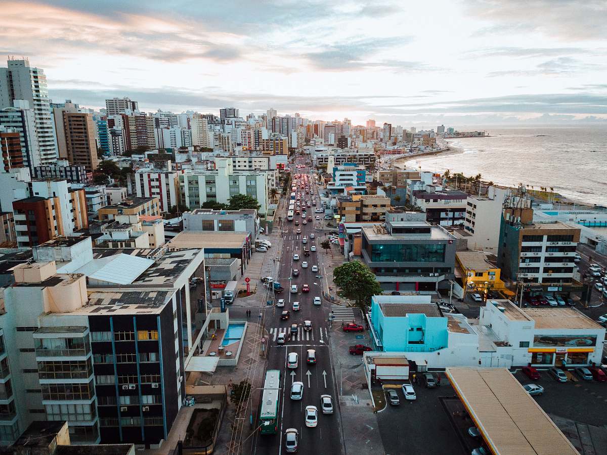 landscape aerial photography of vehicles on road near buildings during daytime nature
