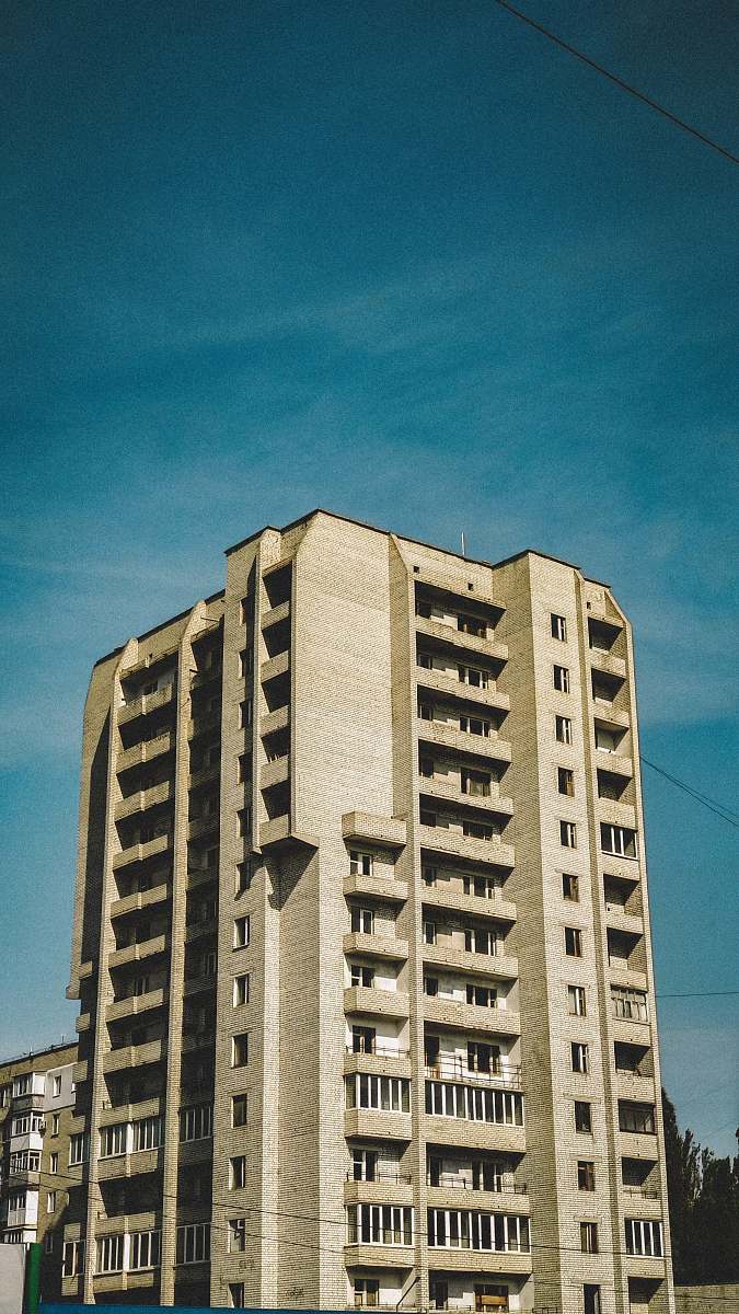 building beige concrete high-rise building during daytime high rise