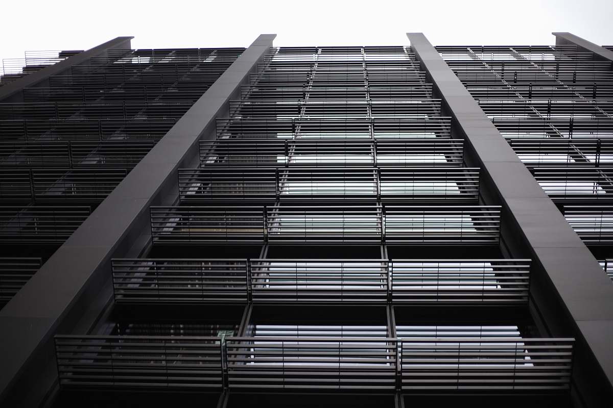 building black tall concrete building during daytime high rise