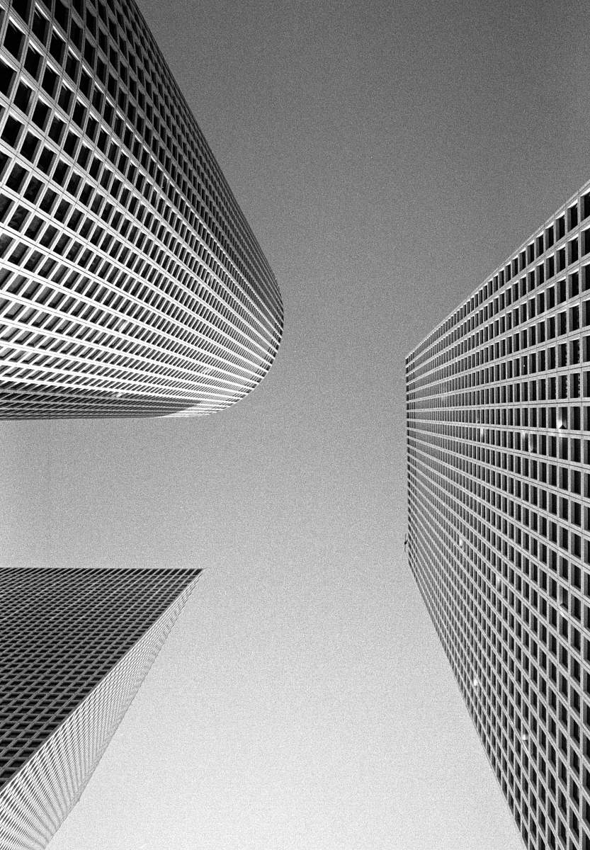 black-and-white bottom view of curtain wall building urban