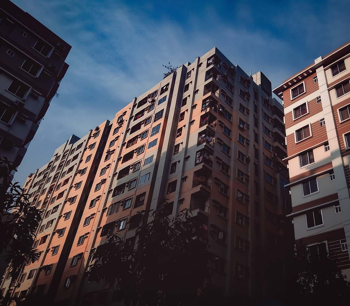 town brown and beige concrete building during daytime high rise