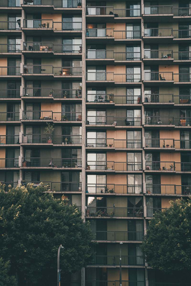 building brown and grey concrete building during daytime high rise