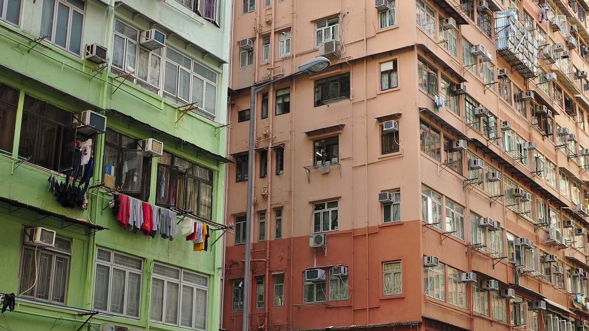 building brown concrete building near green concrete building home decor