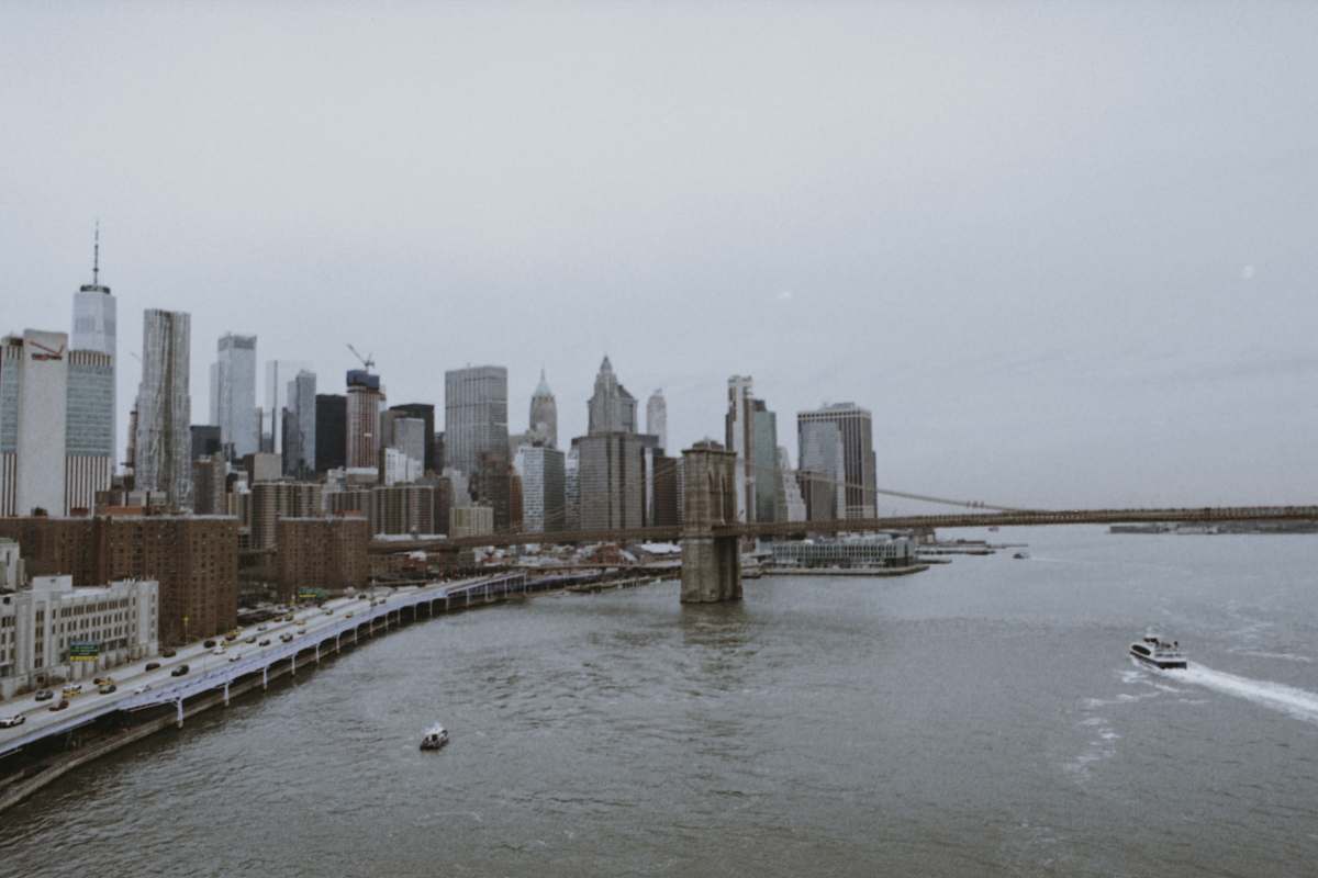 building buildings beside body of water under white sky high rise