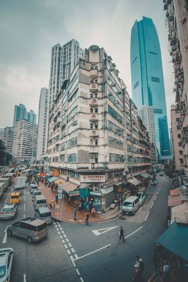 building cars and people walking on road road