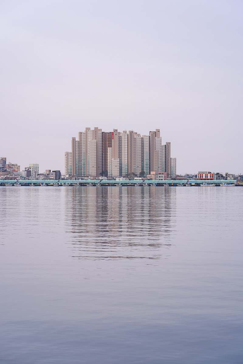 building cityscape near the calm body of water during daytime high rise