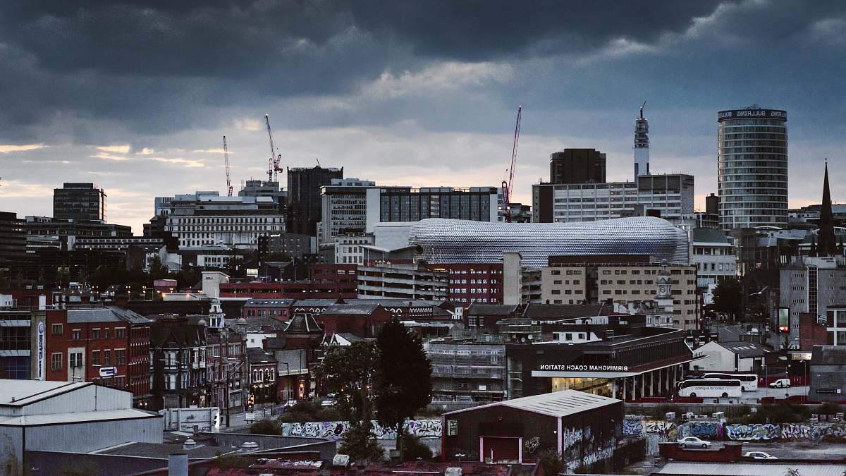 building concrete building and houses under gray sky birmingham
