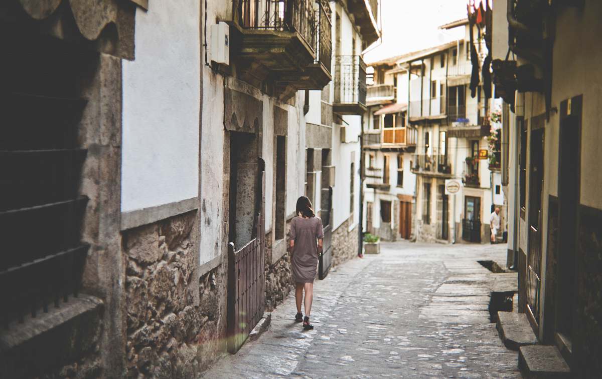 town girl walking along pathway alley