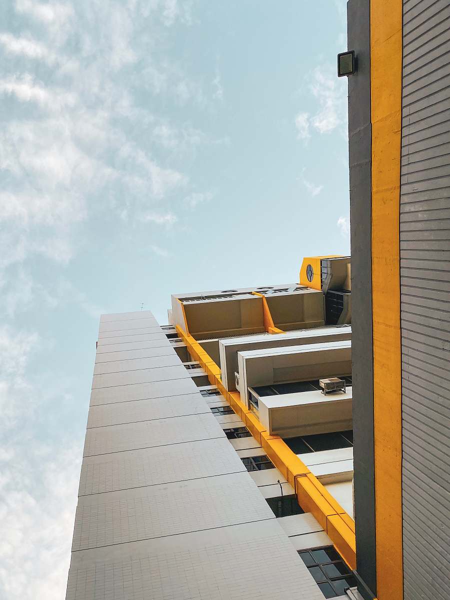 building gray and yellow concrete building at daytime high rise