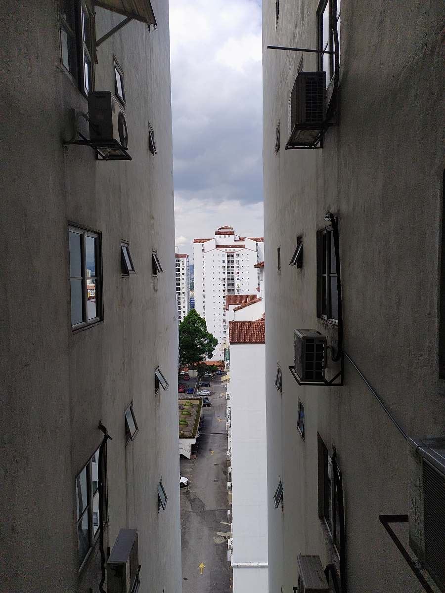 building gray concrete buildings under white skies at daytime road