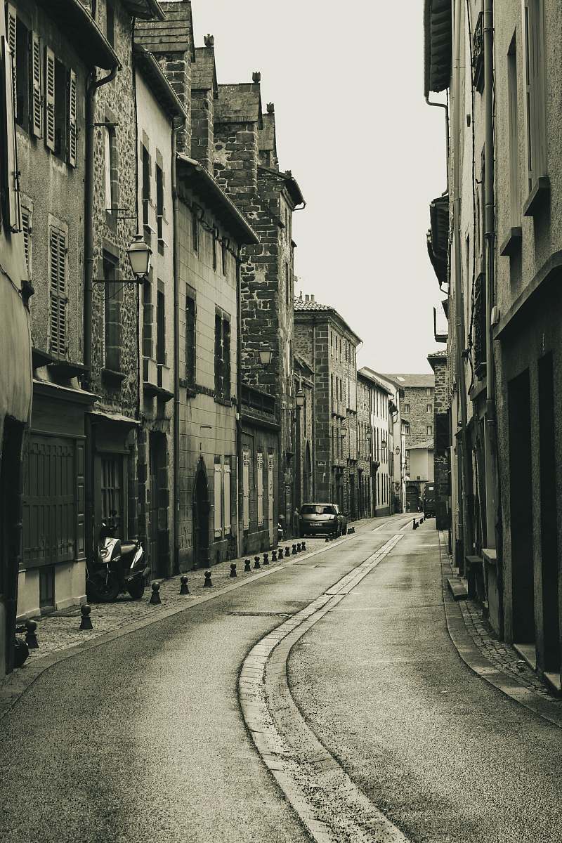 street grayscale photo of black and gray building town