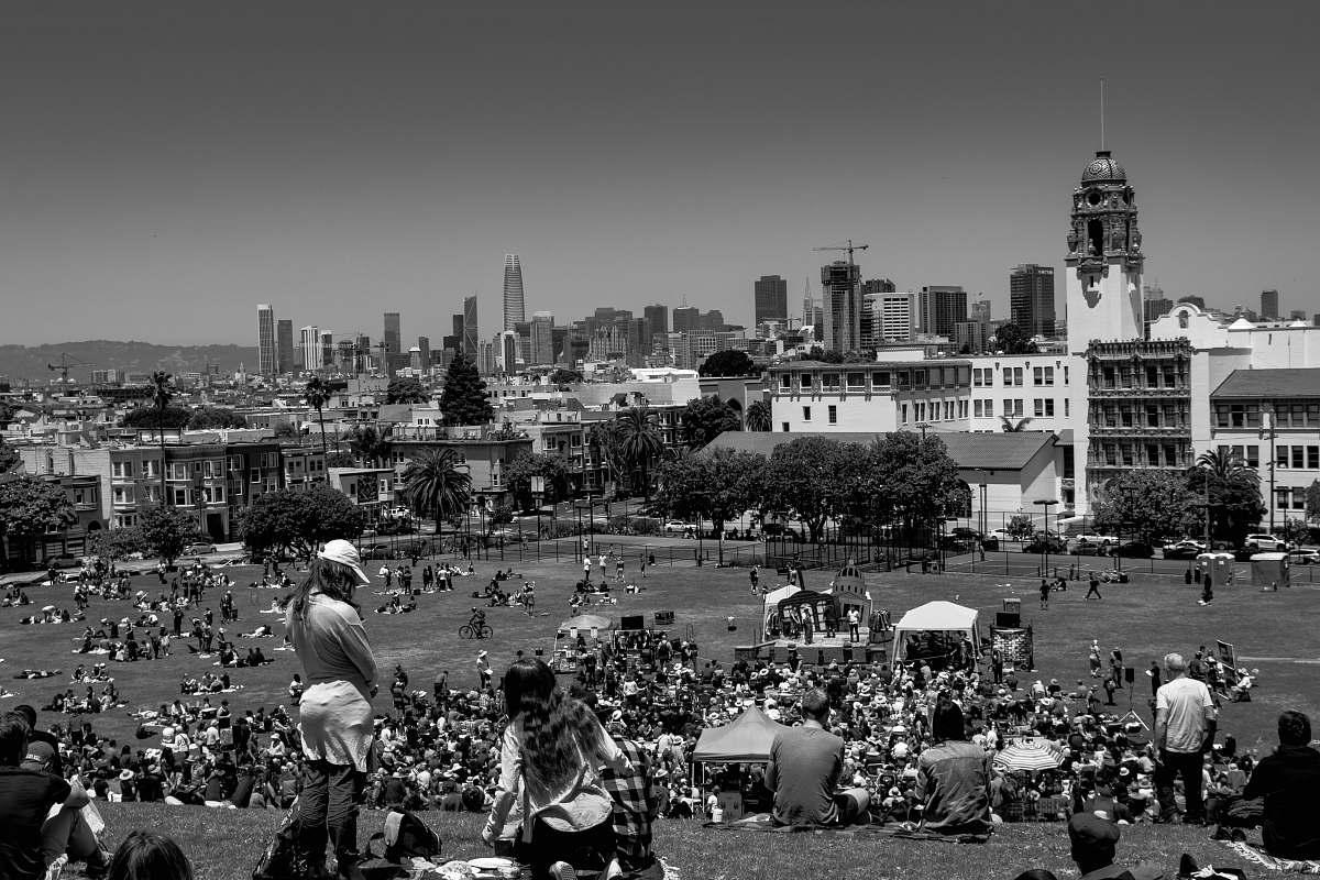 urban grayscale photo of people on field black-and-white