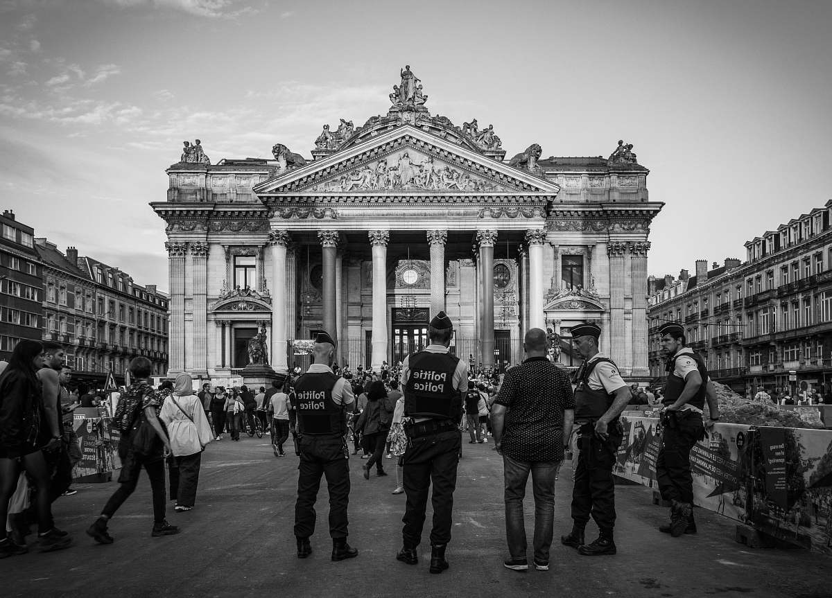 building grayscale photography of people standing near building black-and-white