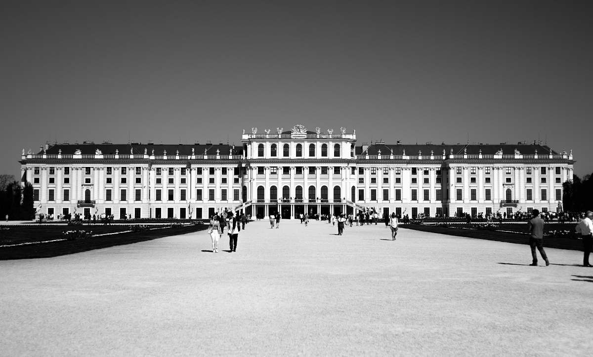 downtown grayscale photography of people waking front of building black-and-white
