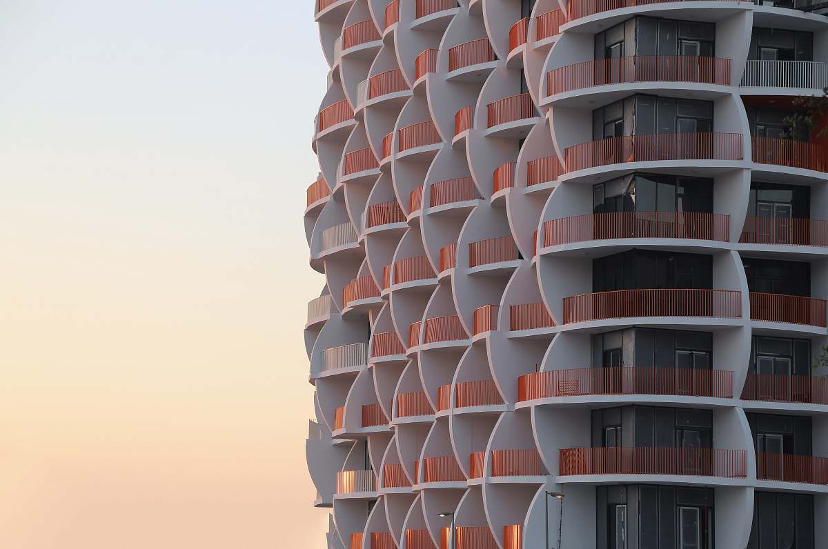 building grey and brown concrete building during daytime high rise