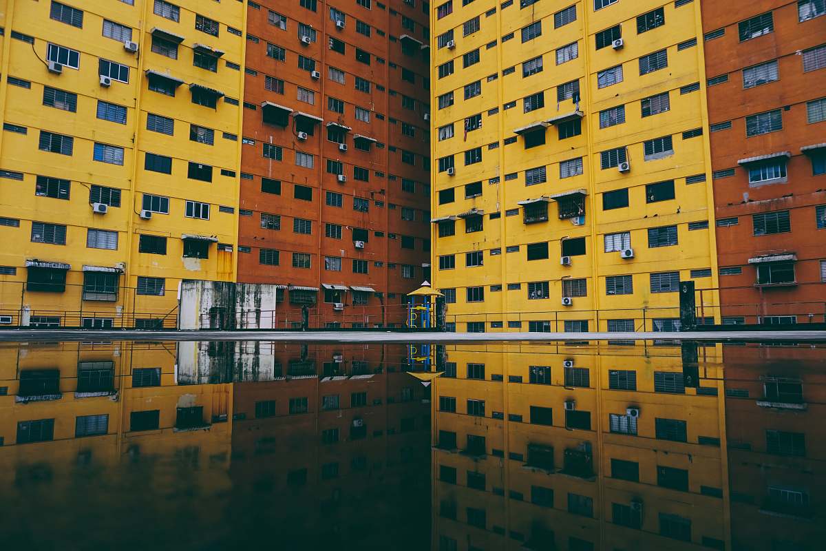 building high-rise building reflection on body of water urban