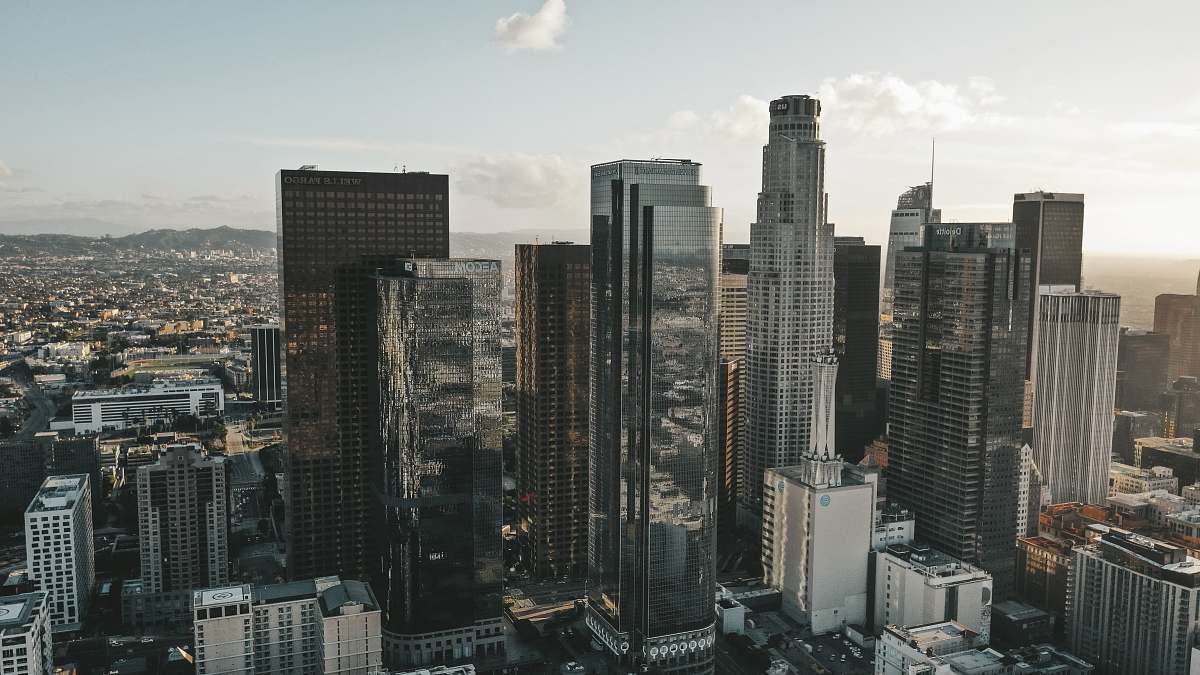 building high rise buildings in city under white louds urban