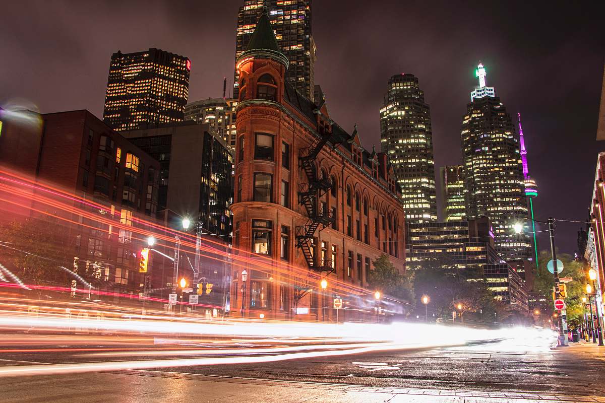 building light streaks photography of vehicle lights on road downtown