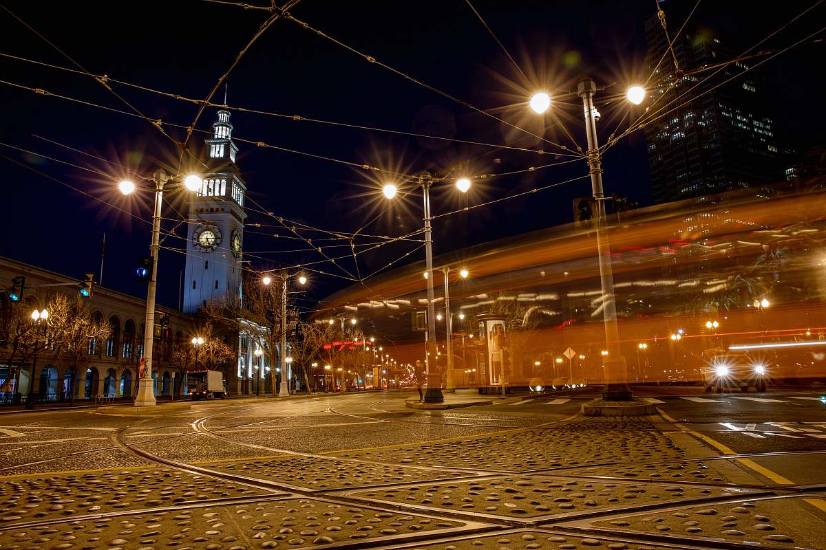 building lighted outdoor lamp post near buildings at night downtown