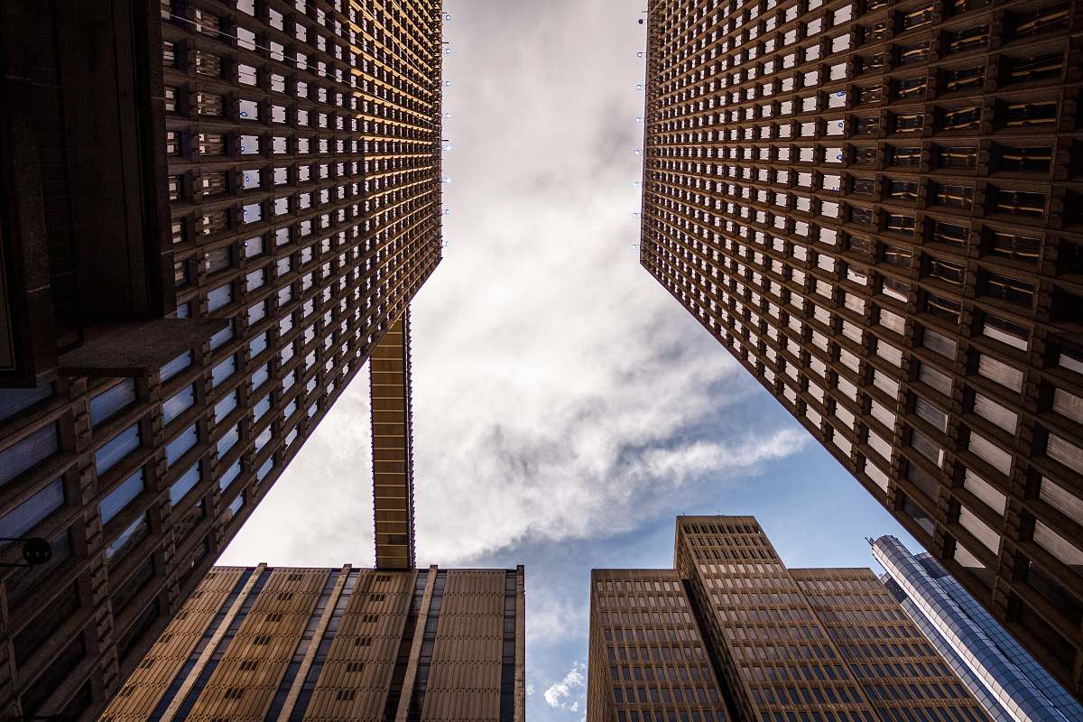 Capture the essence of modern architecture with this striking low angle photograph of towering skyscrapers. This image beautifully showcases the grandeur and scale of high-rise buildings against the sky, making it ideal for use in real estate marketing, urban planning presentations, or architectural design portfolios. Its dynamic perspective invites viewers to appreciate the intricate details and innovative designs of contemporary urban landscapes.