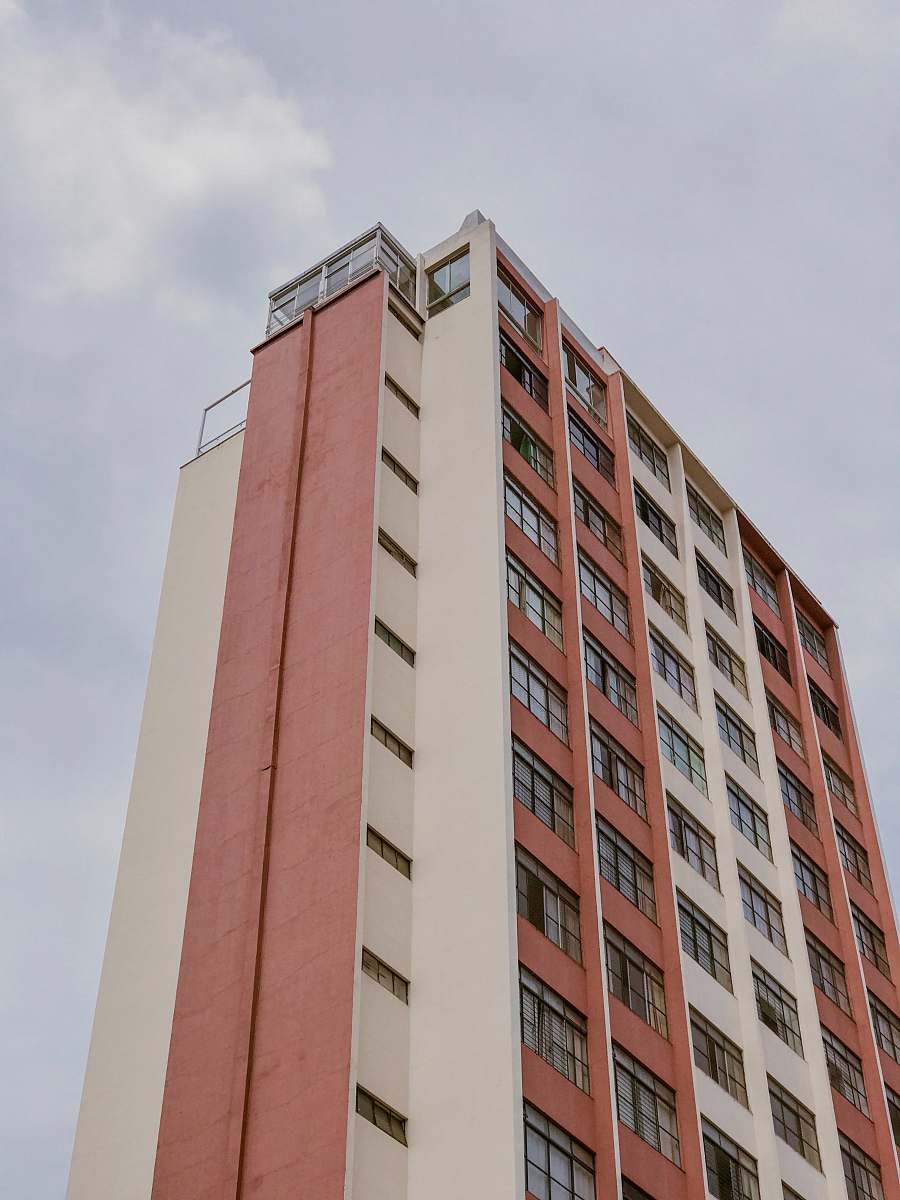 building low-angle photo of orange and white striped building high rise