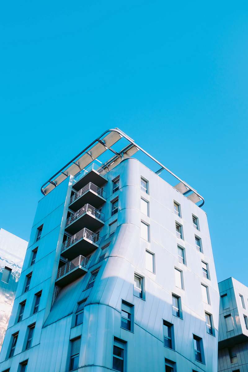 building low-angle photography of a concrete building under a calm blue sky high rise