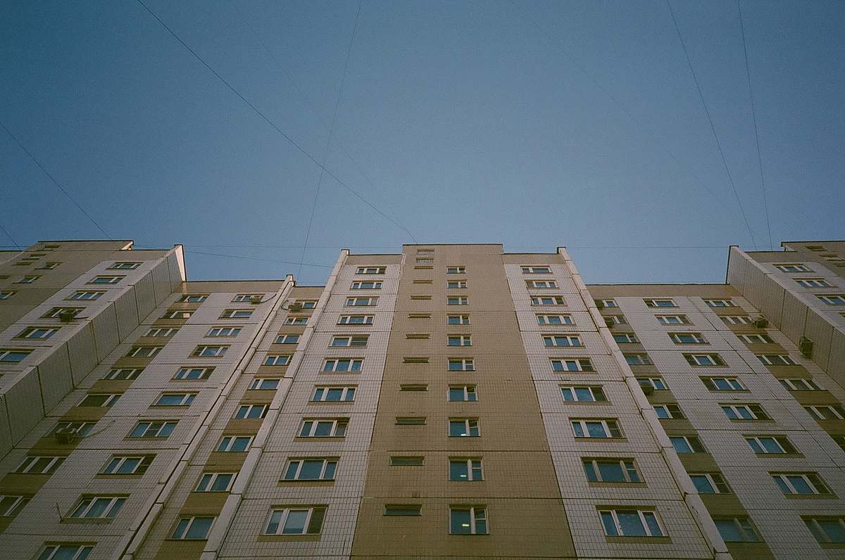 building low angle photography of beige concrete building during daytime high rise