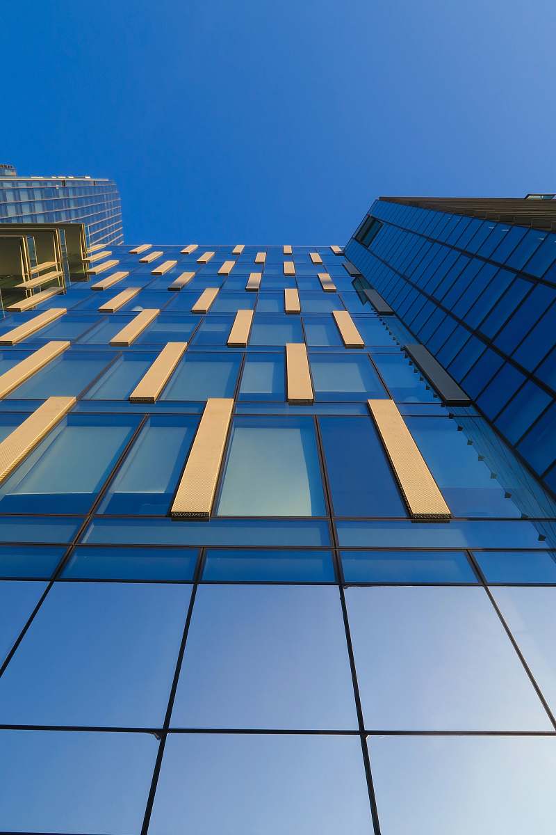 building low-angle photography of blue glass building office building