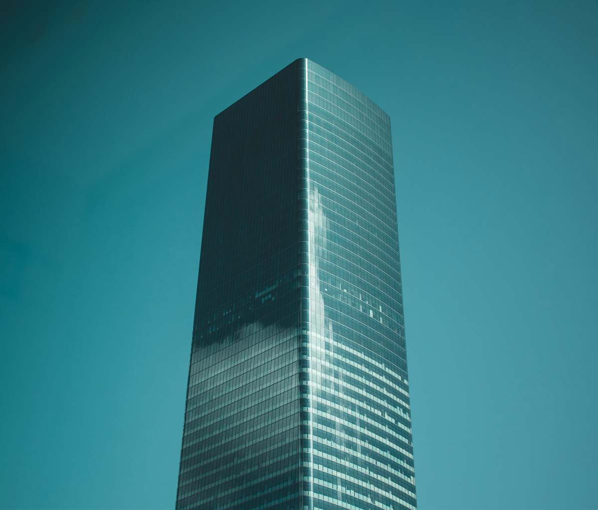 building low-angle photography of blue glass high-rise building high rise