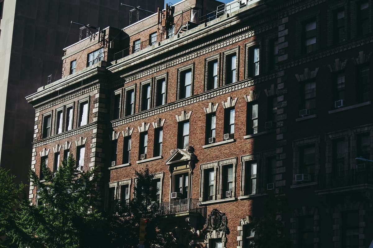 town low-angle photography of brown concrete building high rise
