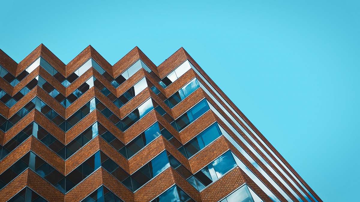 building low angle photography of building under clear blue sky at daytime high rise