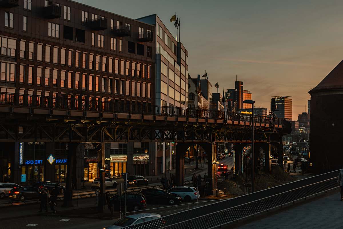 urban low-angle photography of cars on road by buildings town