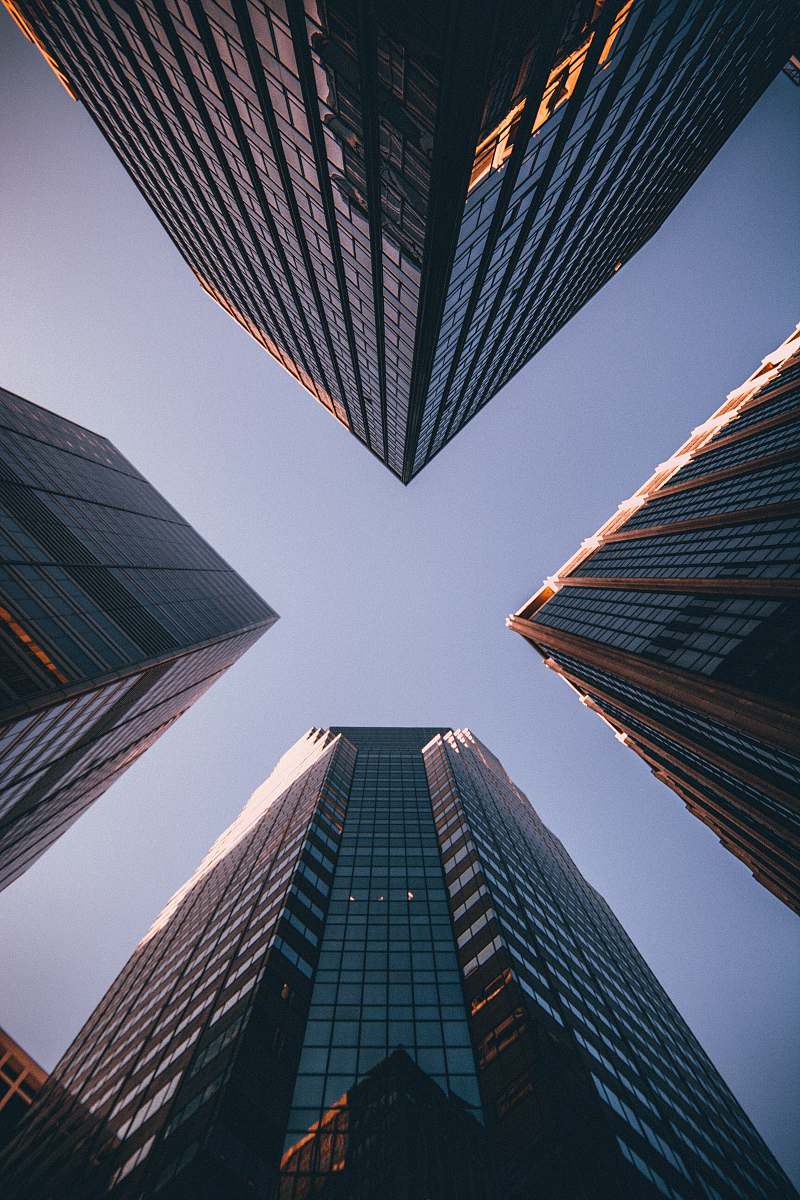 architecture low-angle photography of four high-rise buildings urban