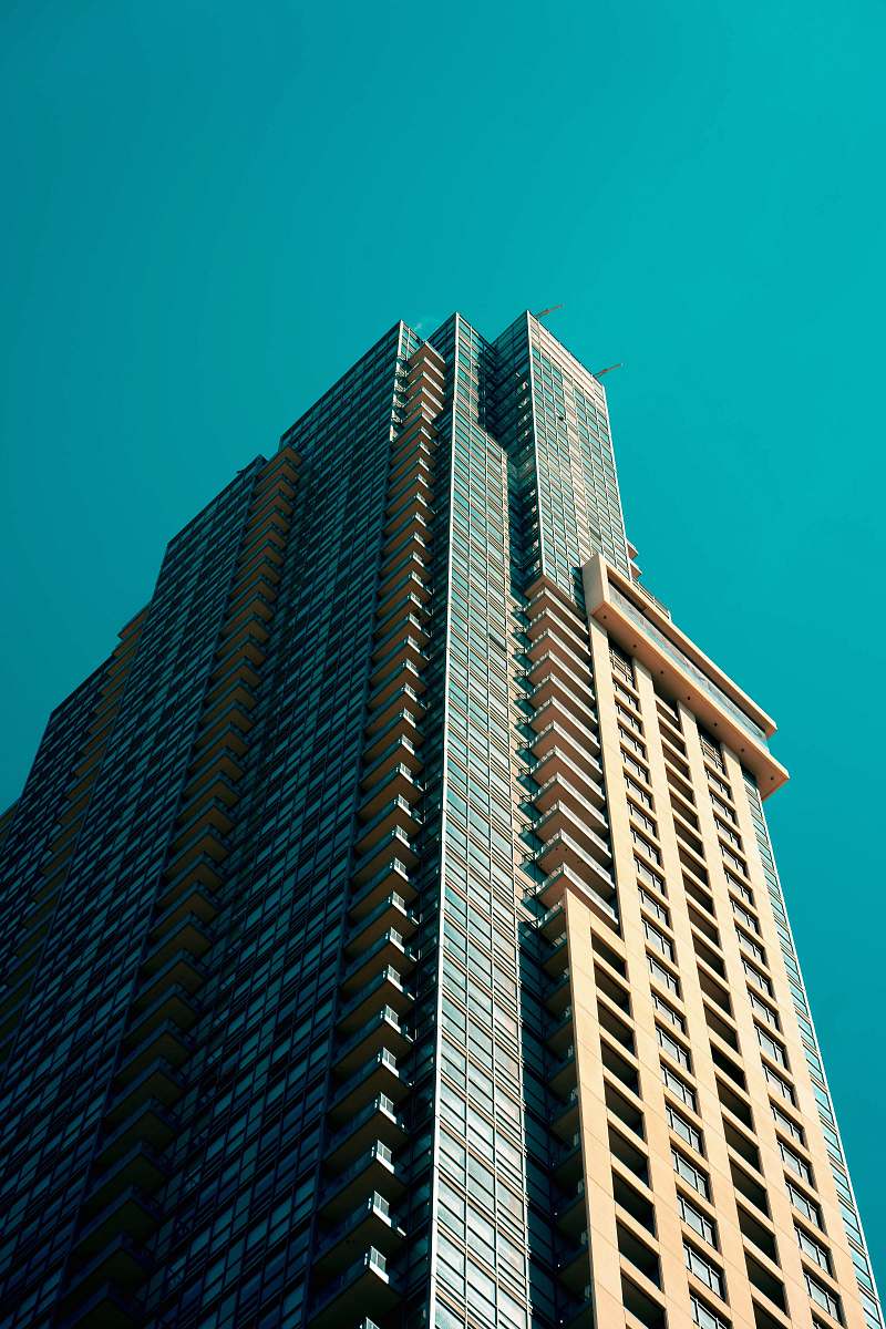 building low angle photography of high rise building under blue sky high rise