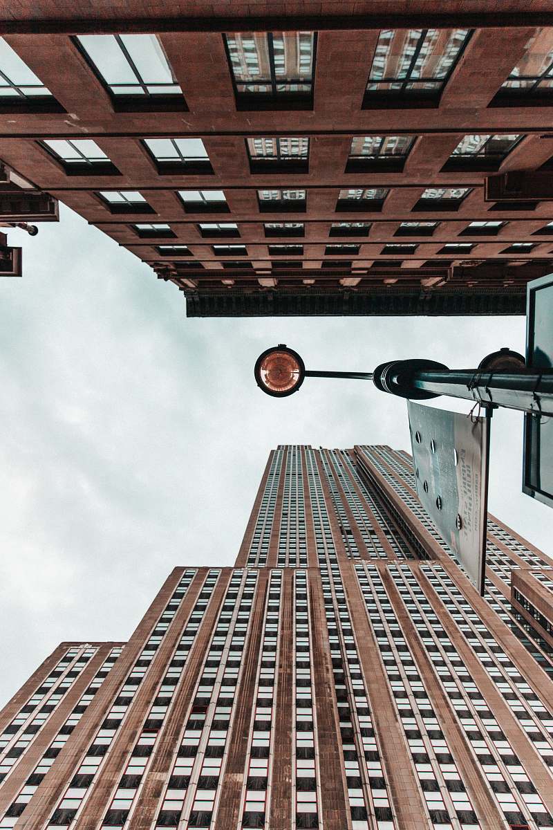 building low angle photography of light post between two high-rise buildings high rise