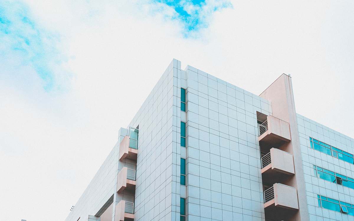 building low angle photography of white and brown concrete building during daytime urban