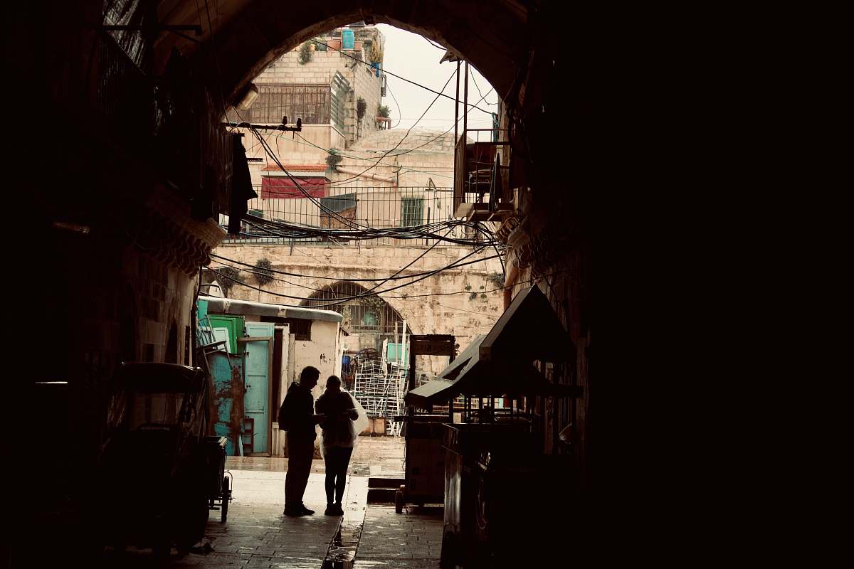 building man and woman standing inside building road