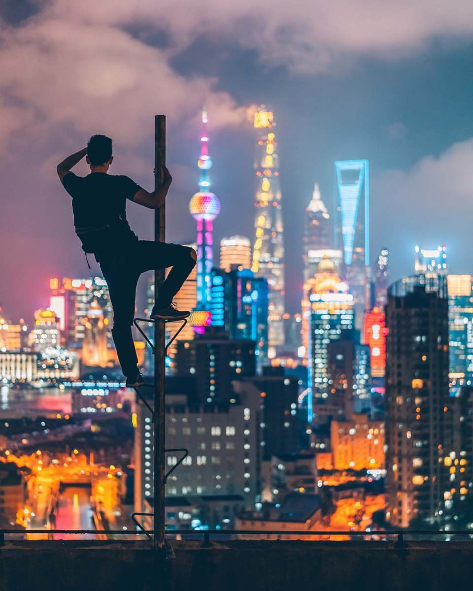 town man climbing on rooftop post urban