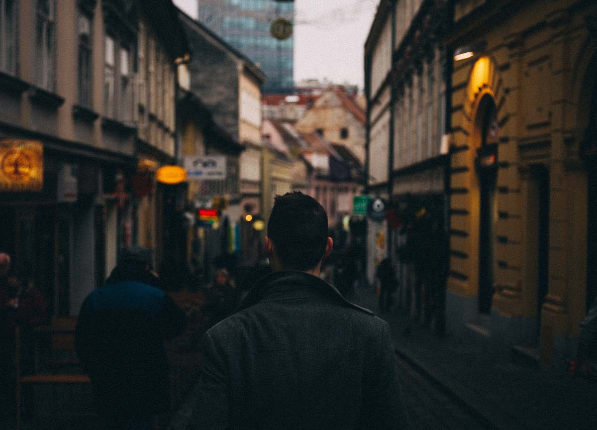street man standing between hallway town