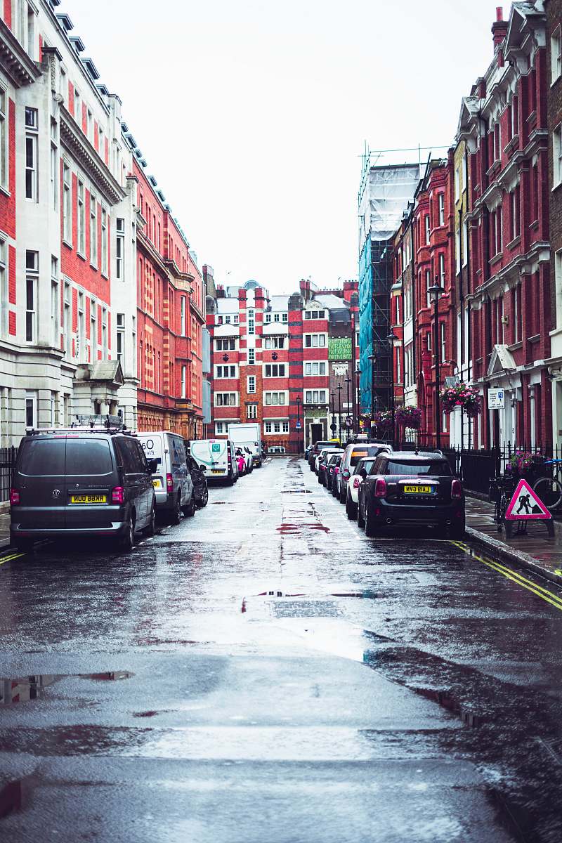 building parked cars beside buildings road