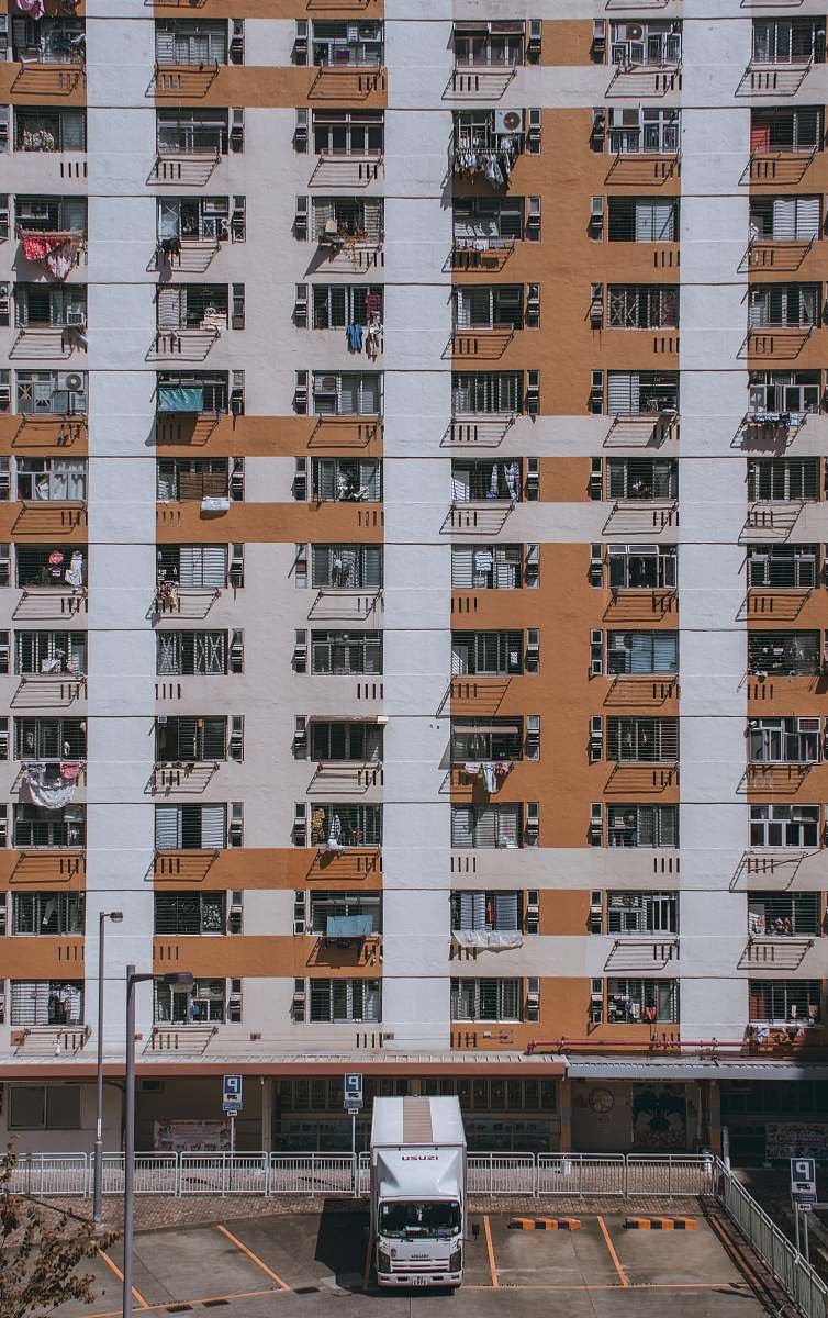 building parked white truck near building during daytime high rise