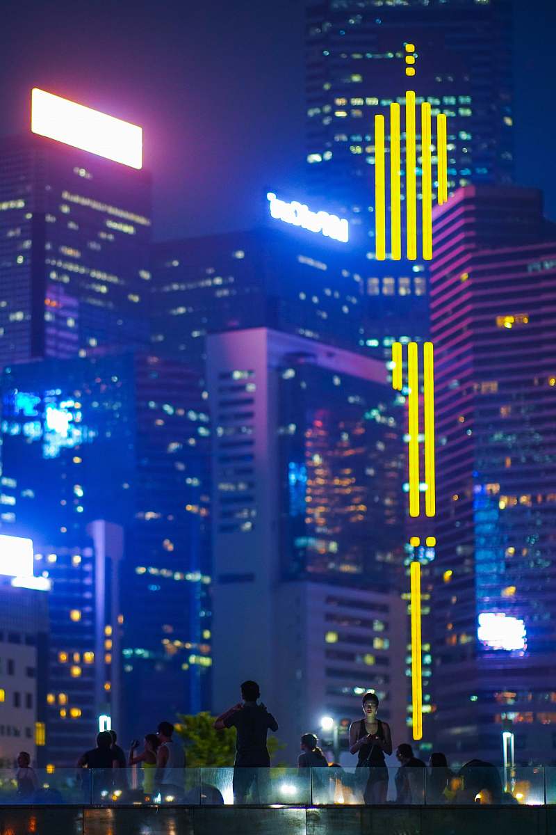 urban people near high rise building at nighttime lighting
