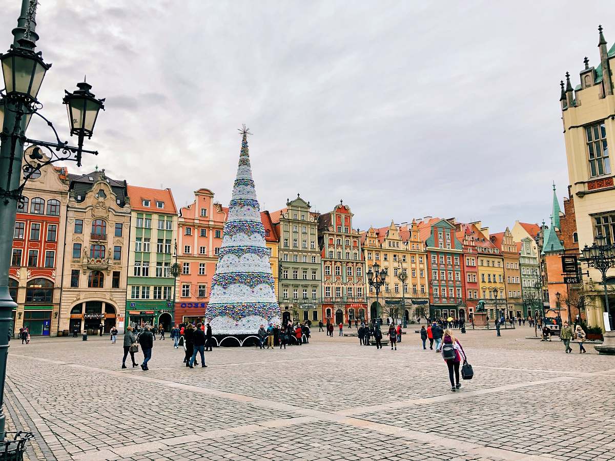 urban people walking beside giant Christmas tree town