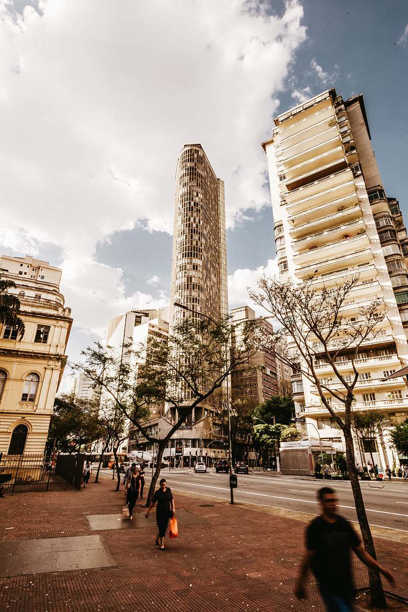 urban people walking beside road at daytime building