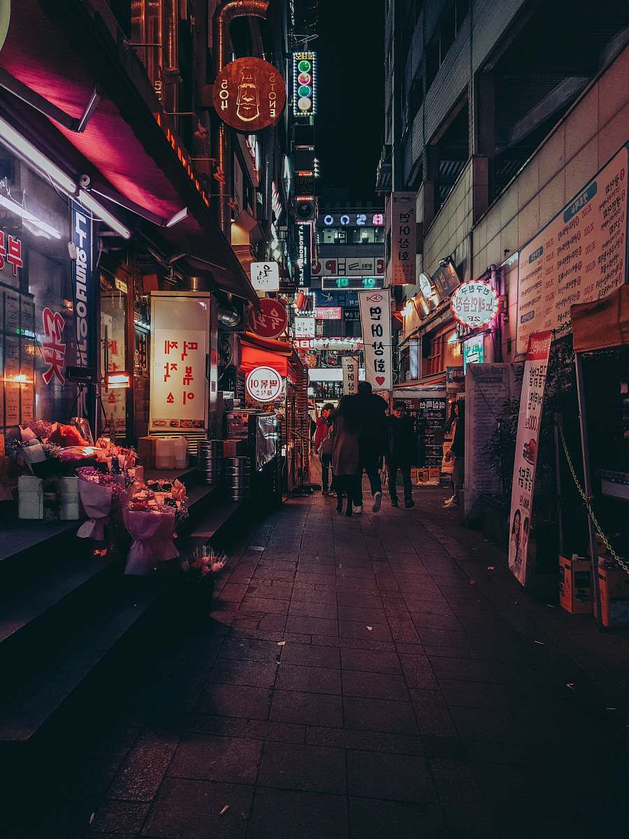 urban people walking between buildings town