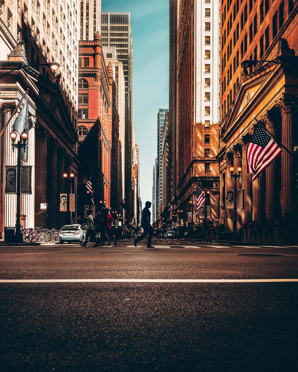 street people walking between concrete buildings building