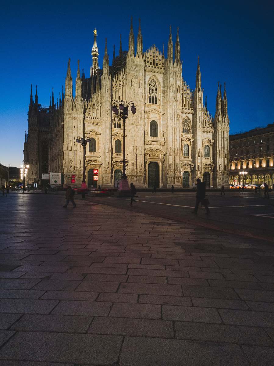 building people walking in front of cathedral downtown