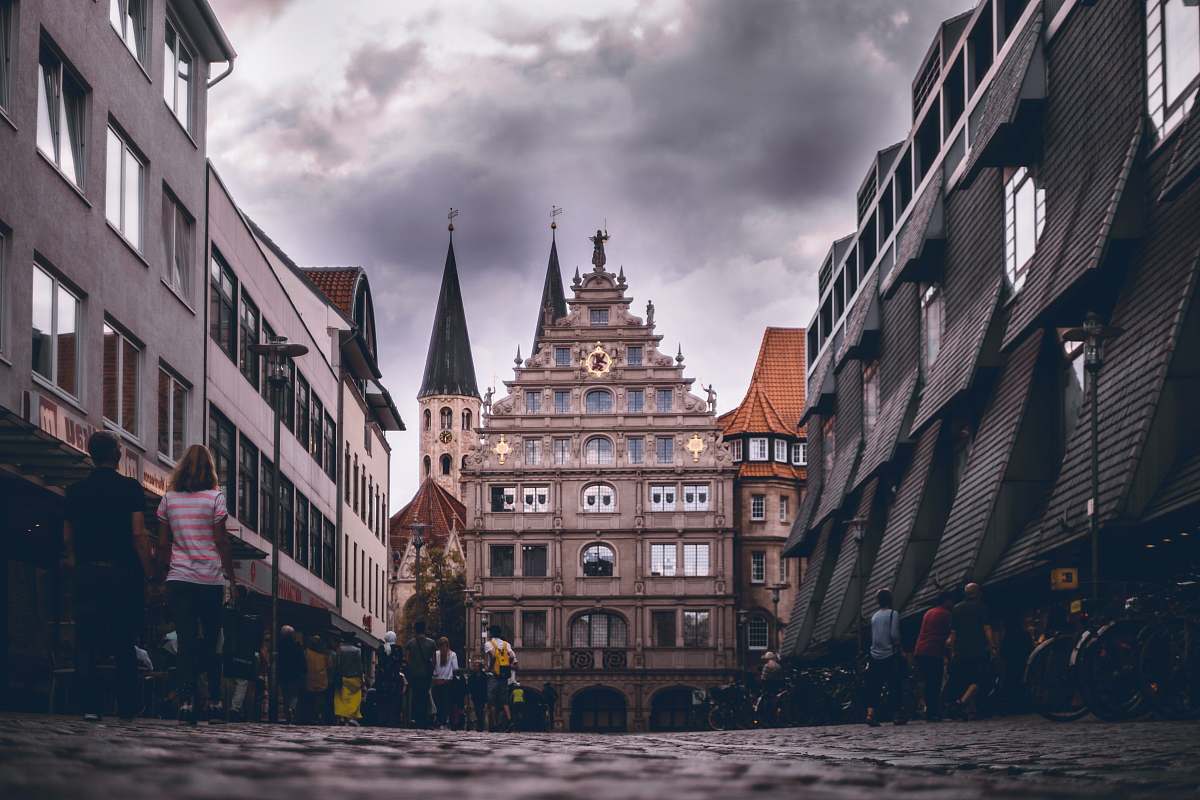 urban people walking near buildings during daytime town