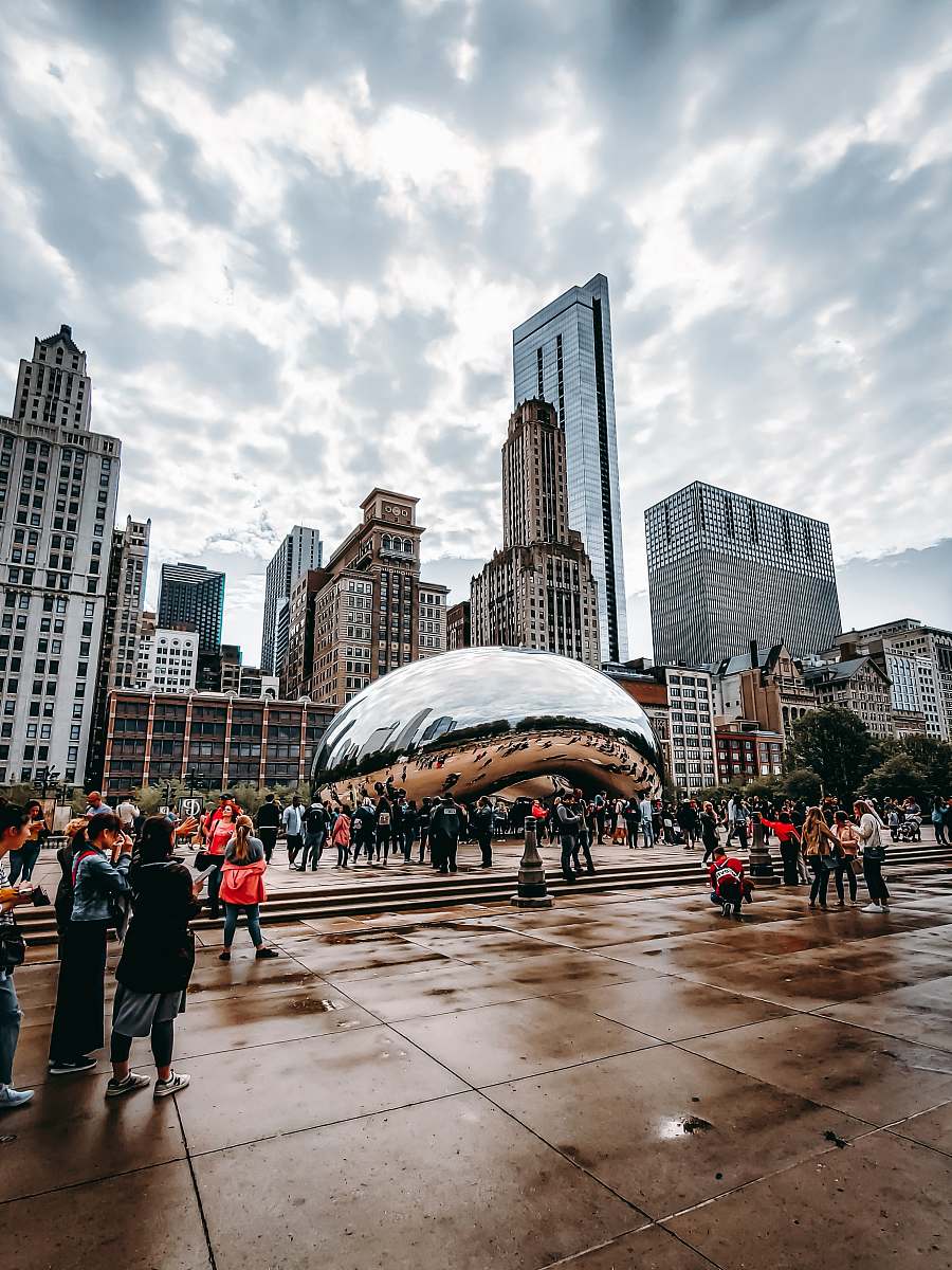 urban people walking near Cloud Gate in Chicago during daytime downtown